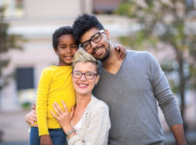 Smiling family of three