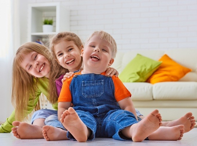 Three children laughing together