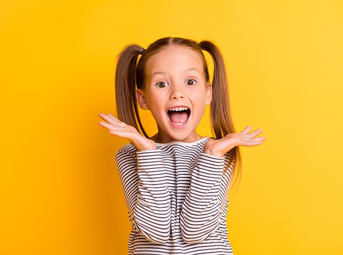Little girl with pigtails, smiling happily