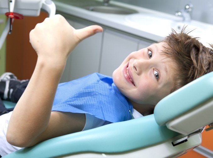 Child smiling during dental checkup and teeth cleaning