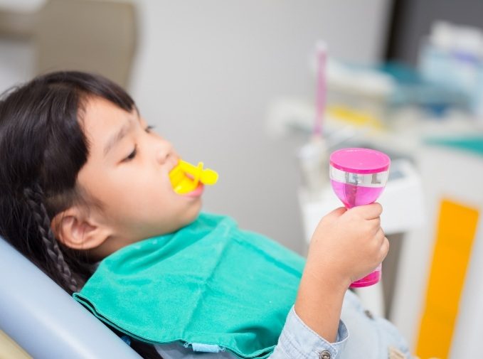 Child receiving fluoride treatment