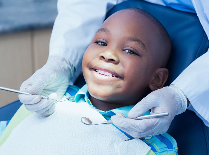 Child smiling in the dental chair