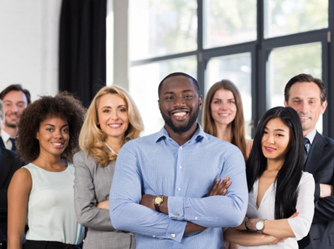Employees at various businesses smiling