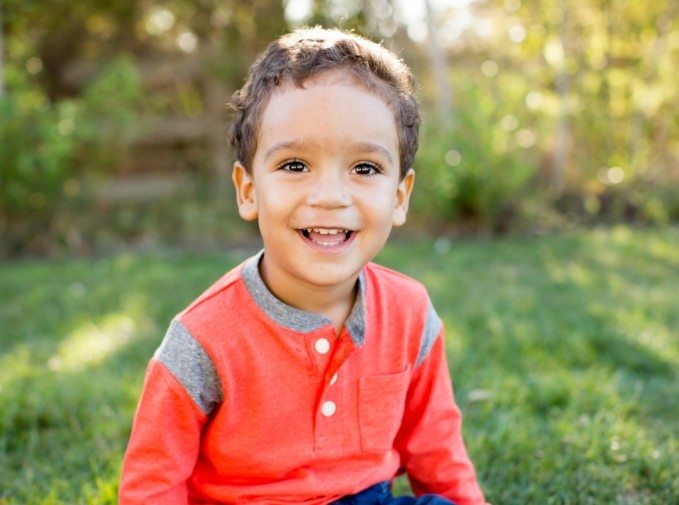 Child with healthy smile after emergency dentistry