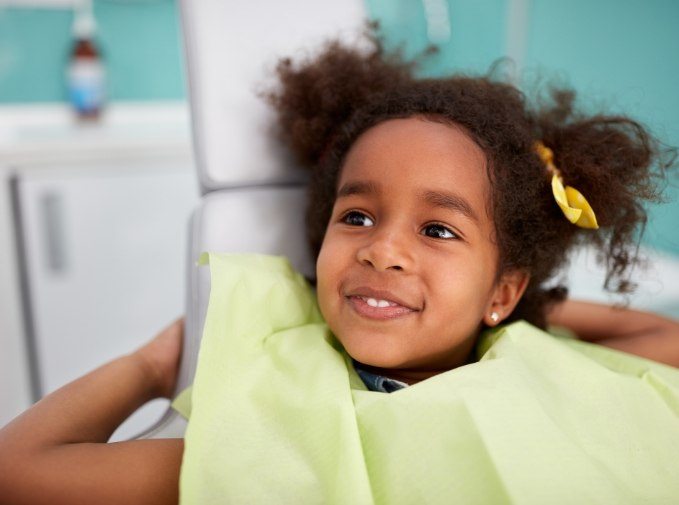 Child smiling after tooth extractions