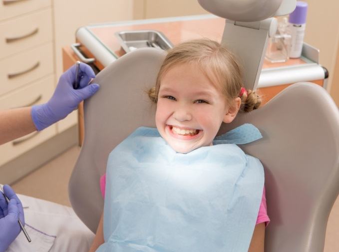 Child smiling after tooth extraction