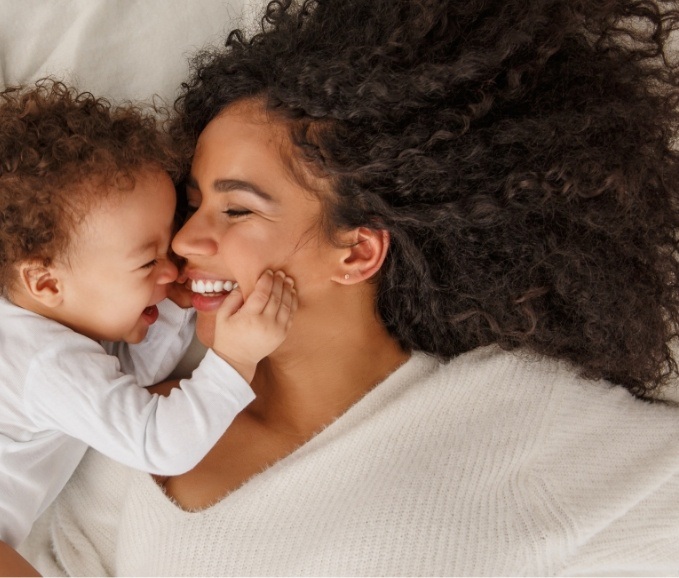 Mother and baby laughing and enjoying the benefits of early intervention