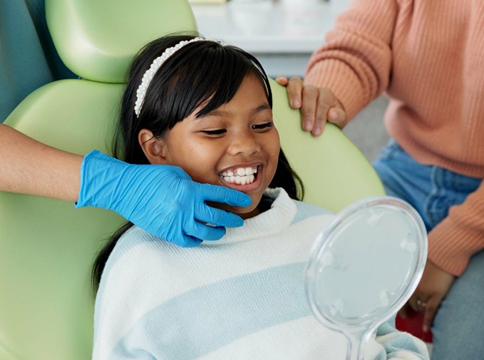 Little girl smiling while in the treatment chair