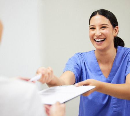 A woman paying for dental treatment