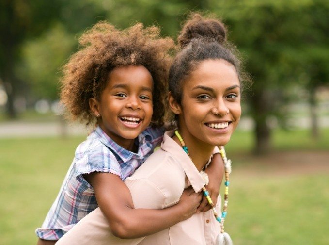 Mother and child smiling after restorative dentistry visit