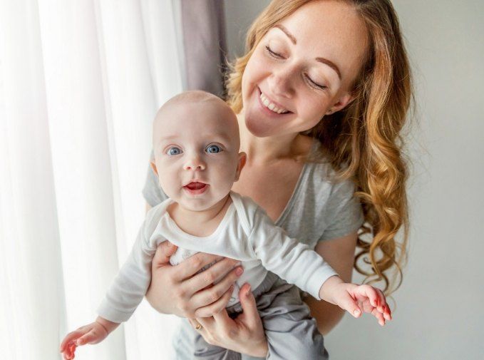 Mother holding smiling baby after all digital x-rays