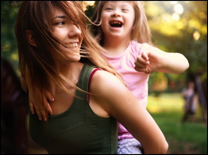 Two young women smiling together after special needs dentistry