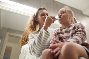 mother brushing her child’s teeth for successful special needs dentistry