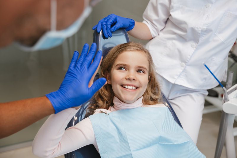 Child smiling in dental chair