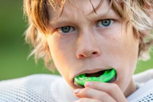 Athlete kid wearing mouthguard. 