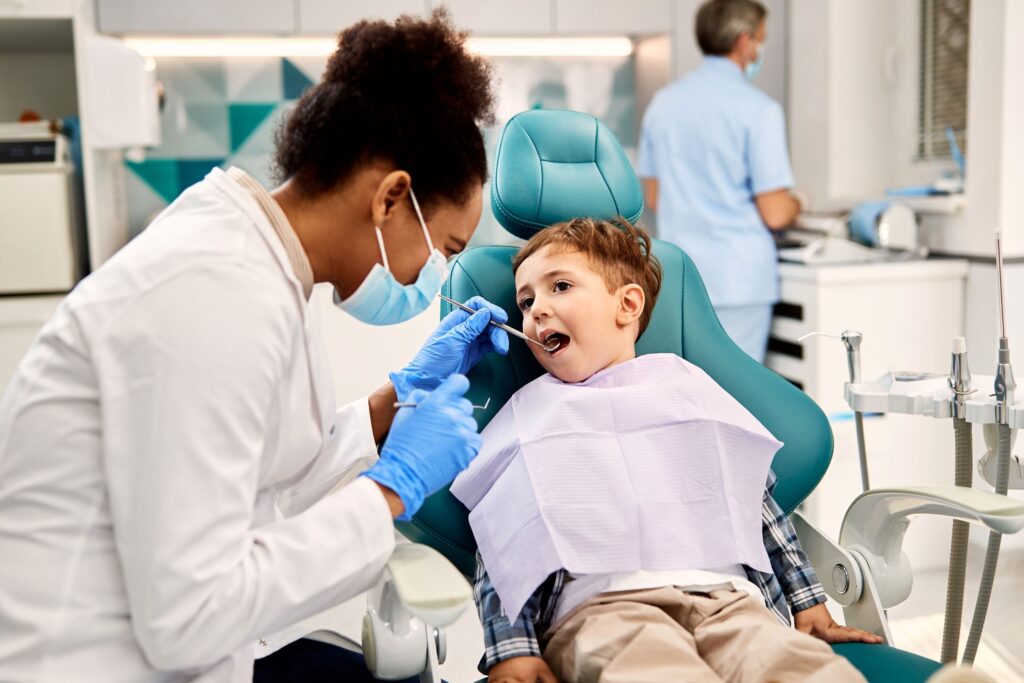 Dentist examining boy's teeth